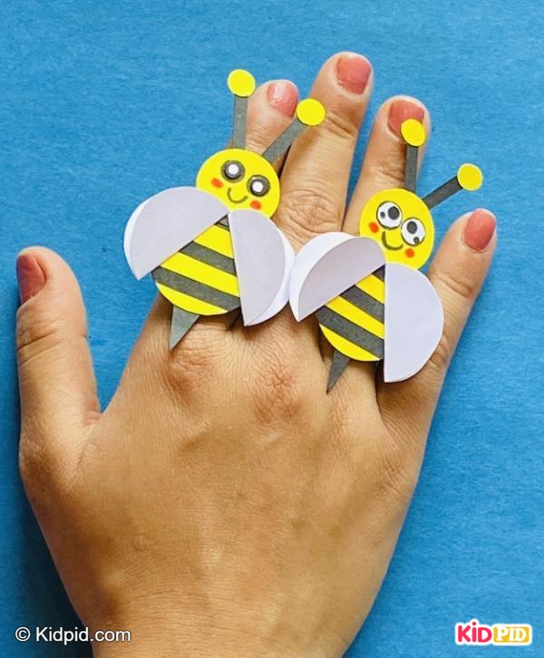 Cute paper bee finger puppets on hand