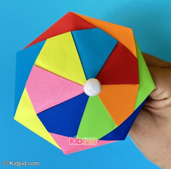 rainbow paper twist toy held in hand